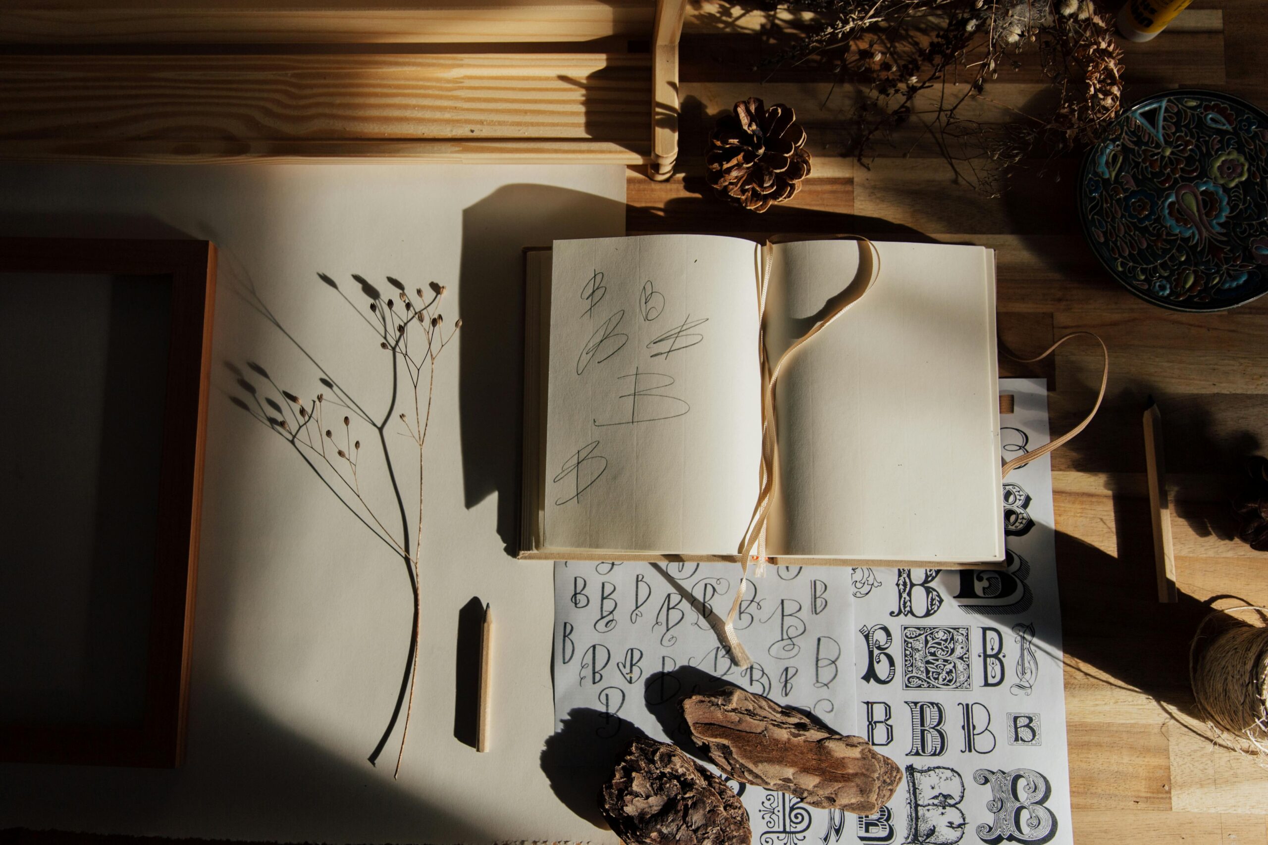 A folded letter beside an open journal on a wooden surface — the visual of examining inherited beliefs in writing.