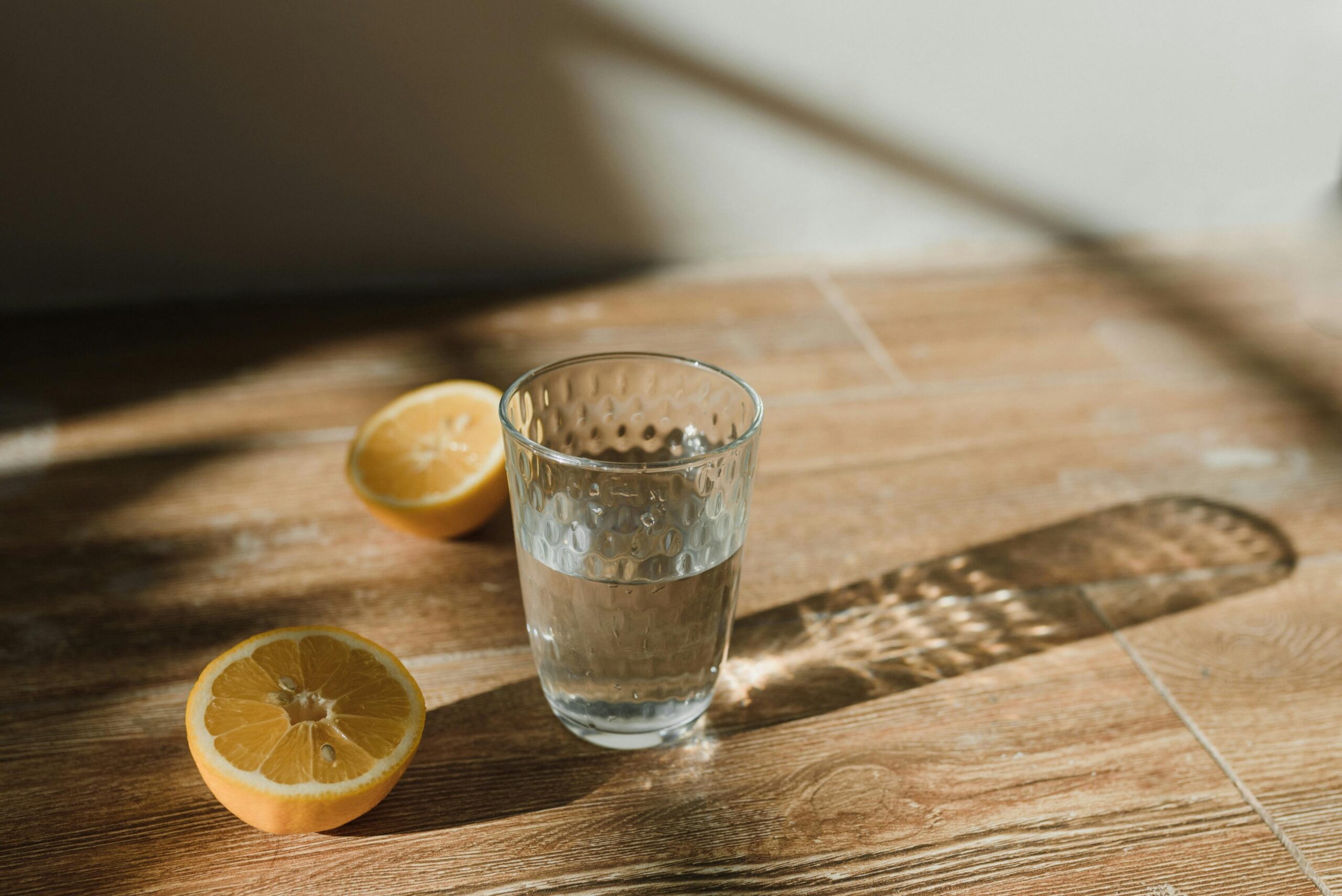 A quiet desk with a journal, a glass of water, and morning light — the visual language of an everyday, sustainable self-care practice.