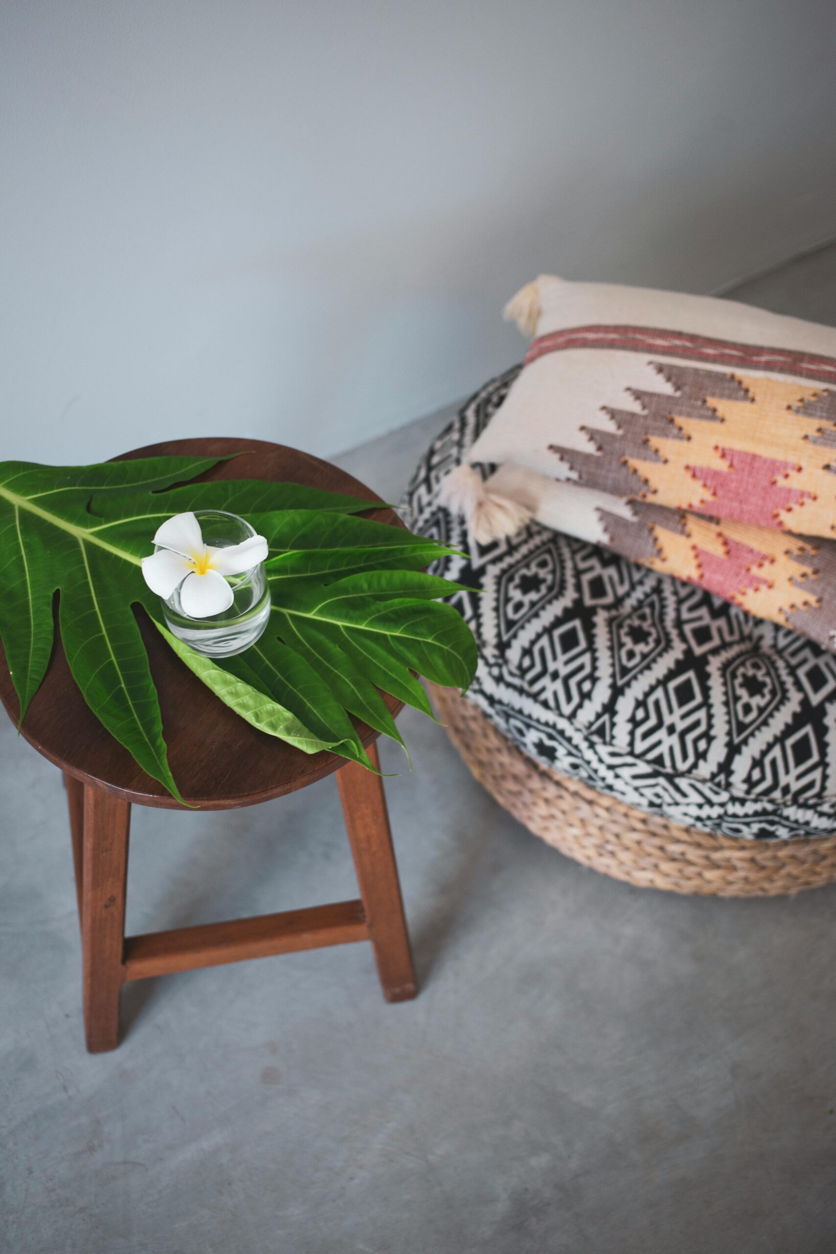 A simple cushion on a wooden chair in soft morning light — the everyday setup of a beginner's meditation practice.