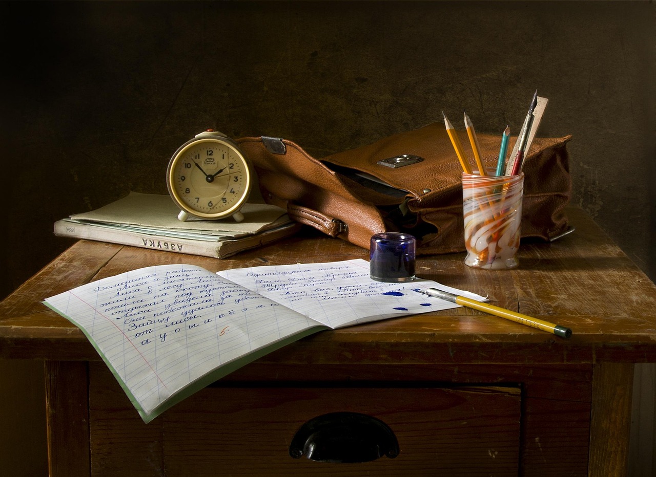 An unfinished page on a wooden desk in soft morning light — half-drafted, ink still wet — the visual of a small creative act made without an audience.